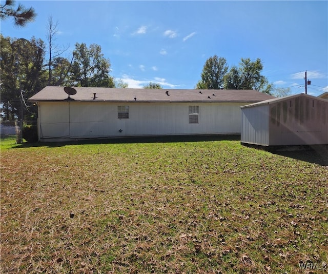 rear view of property with a yard