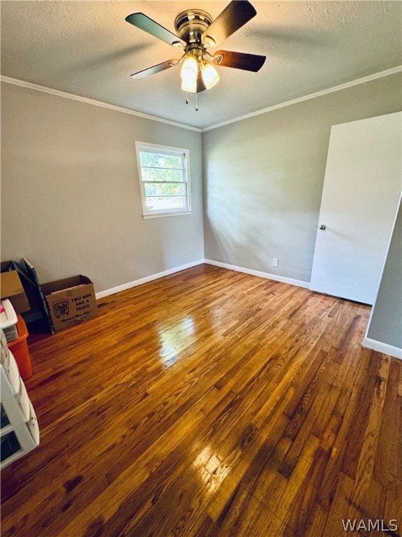 empty room featuring hardwood / wood-style floors, ceiling fan, and ornamental molding