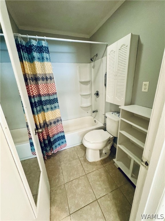 bathroom with tile patterned floors, toilet, and shower / tub combo