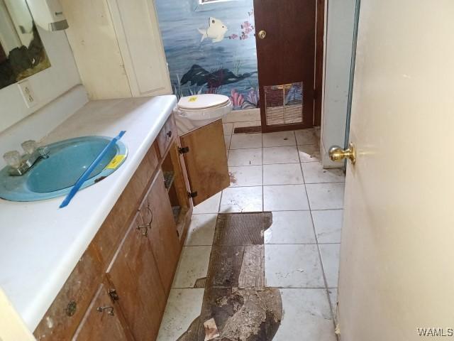 bathroom with tile patterned floors and vanity