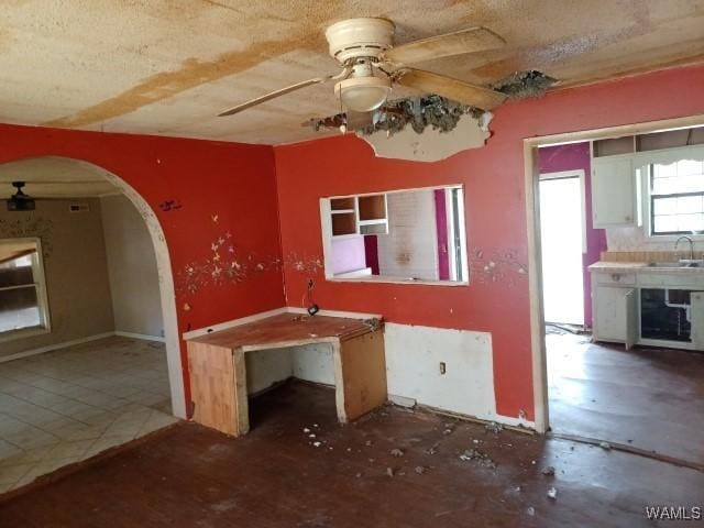 interior space with ceiling fan and sink