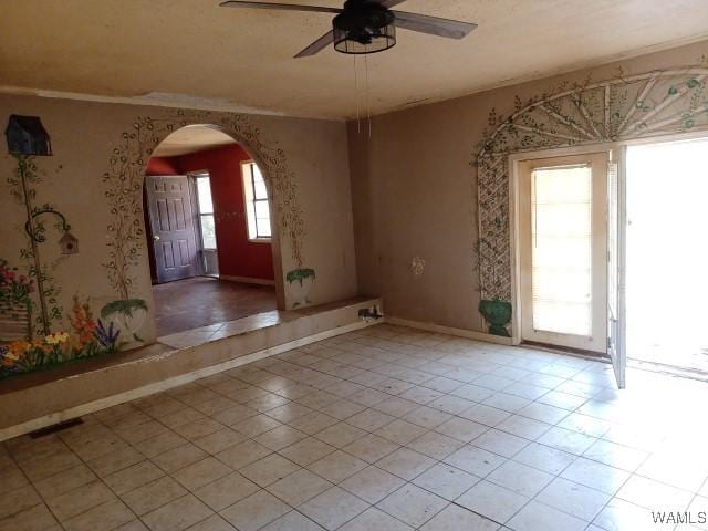 tiled empty room with ceiling fan