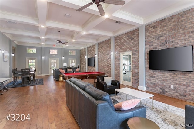 living area with billiards, ceiling fan, wood-type flooring, and brick wall