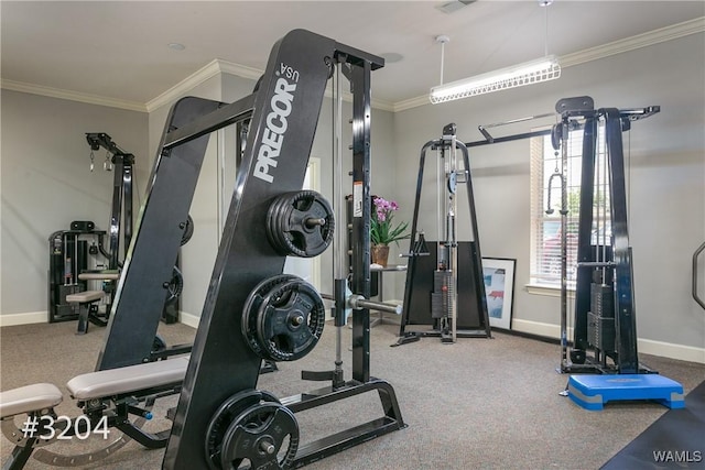 exercise area featuring baseboards, ornamental molding, and carpet floors