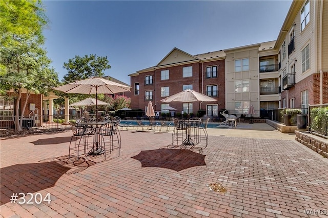exterior space featuring fence, a swimming pool, and a patio