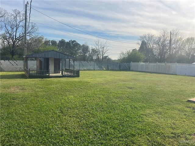 view of yard with a fenced backyard and an outbuilding