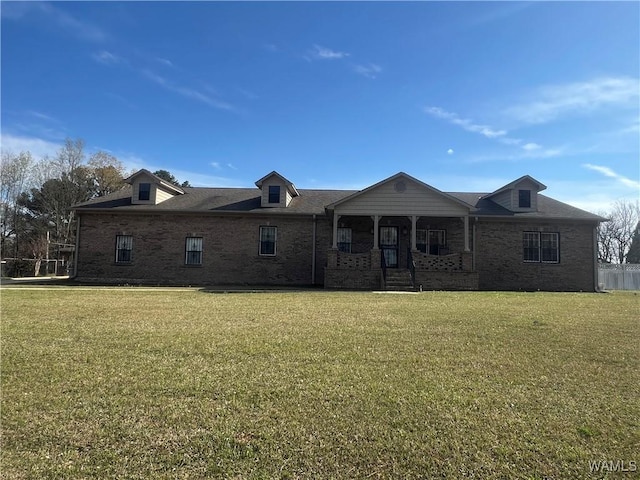 view of front of house with brick siding and a front yard