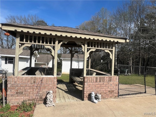exterior space with a storage unit, an outdoor structure, and fence
