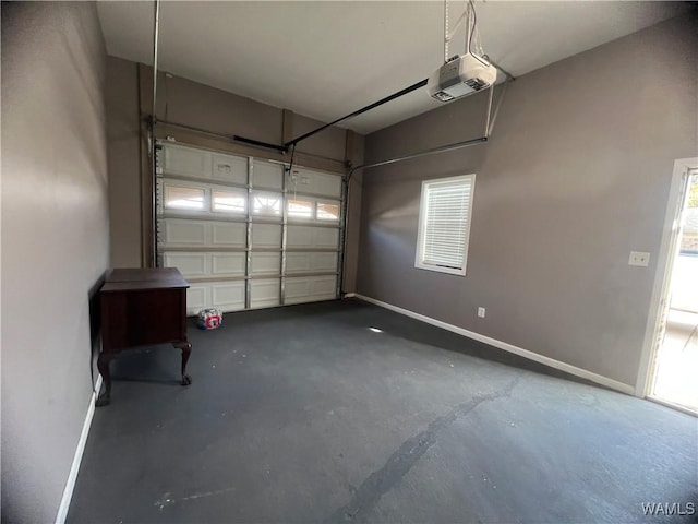 garage with a garage door opener and baseboards