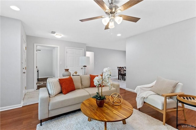 living room featuring ceiling fan and wood-type flooring