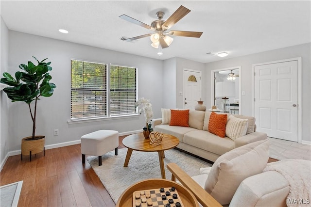 living room with hardwood / wood-style flooring and ceiling fan