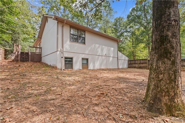 view of property exterior with a deck