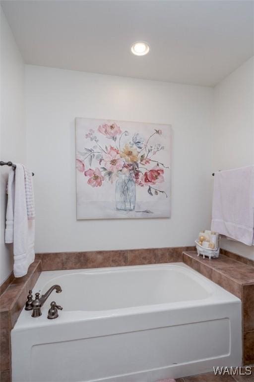 bathroom featuring a bath and recessed lighting