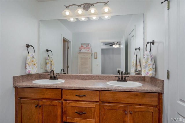 bathroom featuring ceiling fan, a sink, and double vanity