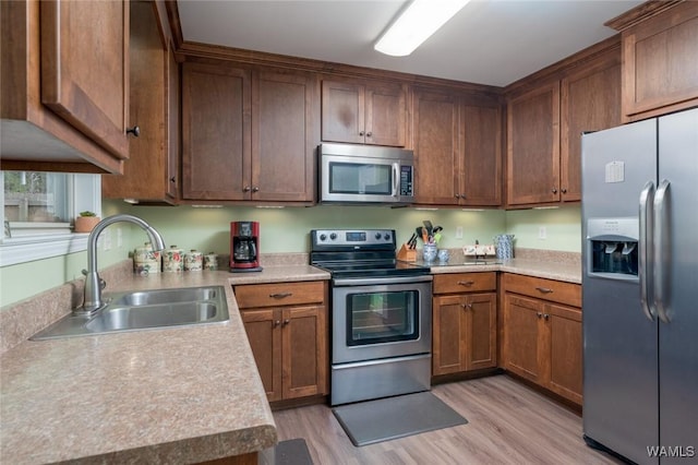 kitchen with stainless steel appliances, light countertops, and a sink