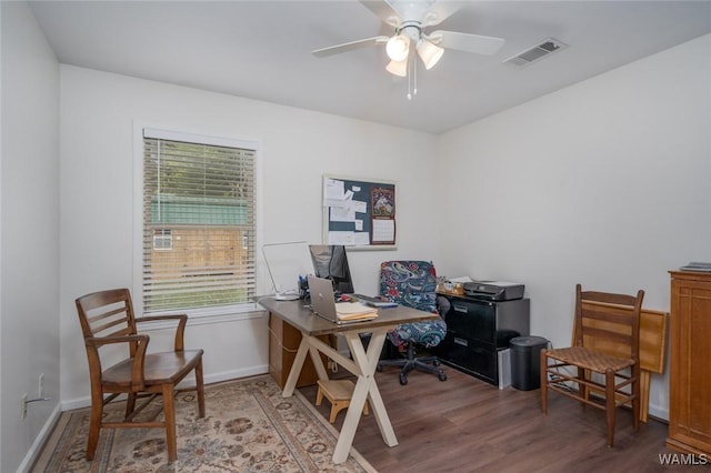 office area with a ceiling fan, baseboards, visible vents, and wood finished floors