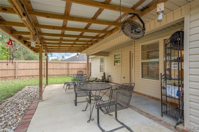 view of patio / terrace with a ceiling fan, outdoor dining space, and fence