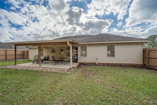 back of property featuring a yard, a fenced backyard, and a patio