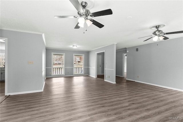 unfurnished living room featuring dark wood-style floors, baseboards, and crown molding