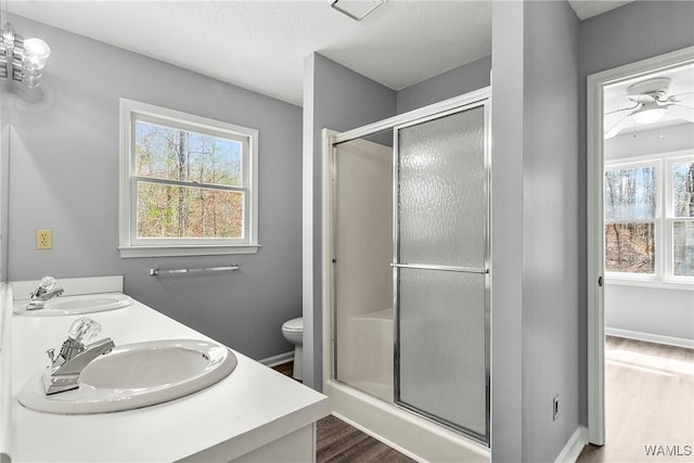 bathroom featuring plenty of natural light, a sink, and toilet