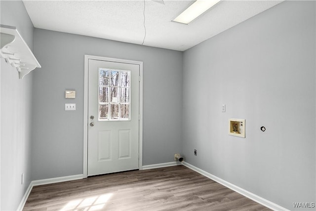 washroom with washer hookup, electric dryer hookup, light wood-type flooring, laundry area, and baseboards