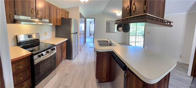 4247 W Ashby Rd, Brierfield, AL 35035 - kitchen with under cabinet range hood, appliances with stainless steel finishes, vaulted ceiling, light countertops, and light wood-style floors