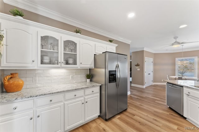 20892 Sharon Dr, Lake View, AL 35111 - kitchen with white cabinetry, tasteful backsplash, glass insert cabinets, stainless steel appliances, and ornamental molding