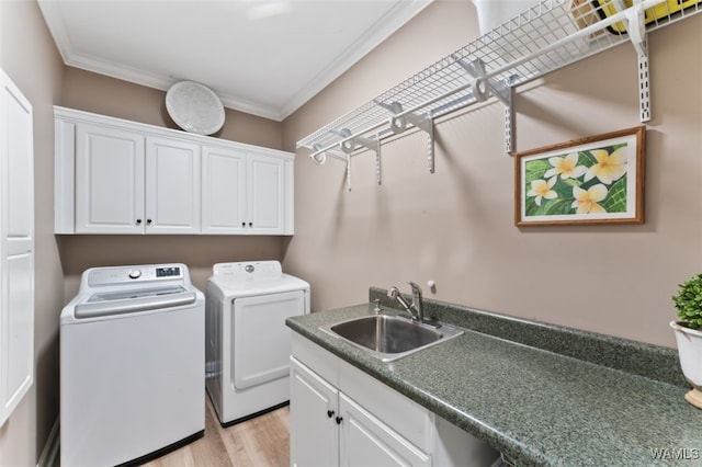 20892 Sharon Dr, Lake View, AL 35111 - laundry room featuring crown molding, washing machine and clothes dryer, a sink, light wood finished floors, and cabinet space