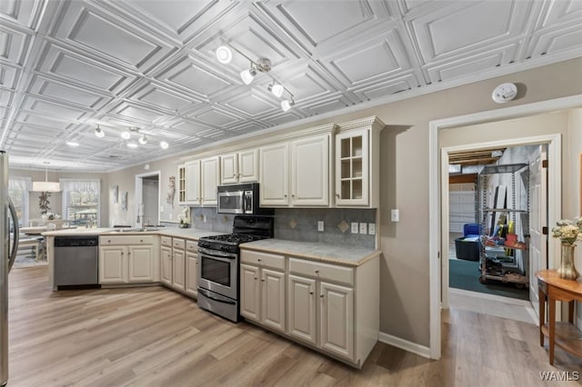 20892 Sharon Dr, Lake View, AL 35111 - kitchen featuring a peninsula, appliances with stainless steel finishes, an ornate ceiling, and decorative backsplash