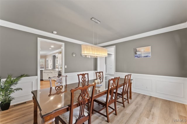 20892 Sharon Dr, Lake View, AL 35111 - dining room with ornamental molding, visible vents, light wood-style floors, and wainscoting