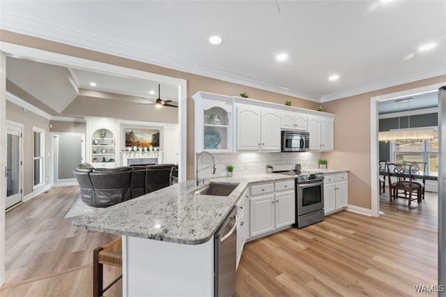 20892 Sharon Dr, Lake View, AL 35111 - kitchen with crown molding, a sink, white cabinetry, a peninsula, and stainless steel appliances