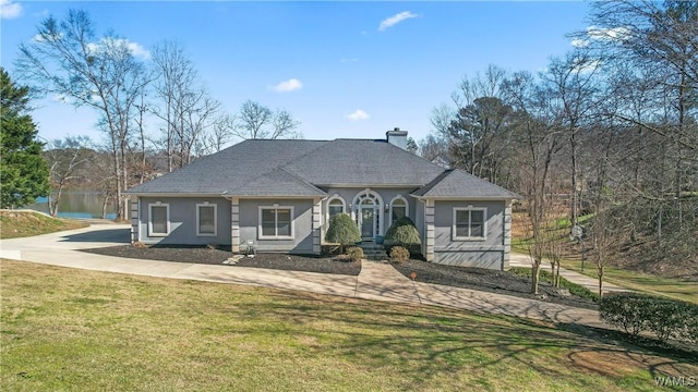 20892 Sharon Dr, Lake View, AL 35111 - view of front of house featuring stucco siding, a chimney, a front lawn, and roof with shingles