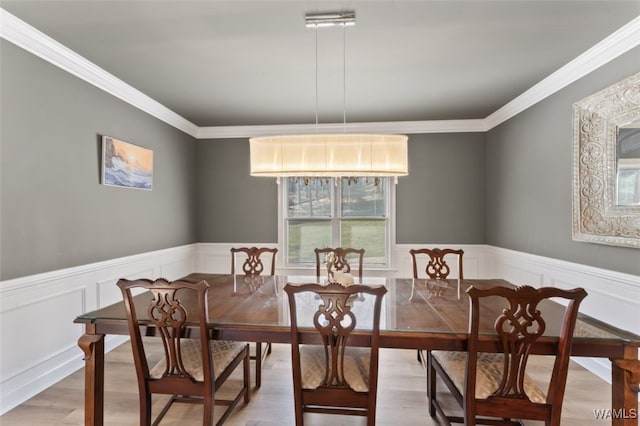 20892 Sharon Dr, Lake View, AL 35111 - dining area with a wainscoted wall, crown molding, and light wood-style flooring