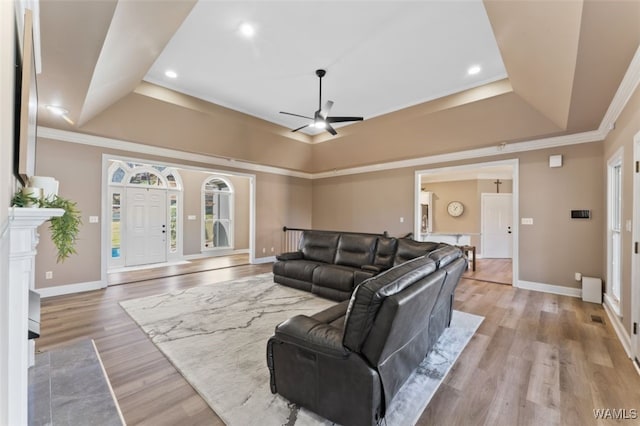 20892 Sharon Dr, Lake View, AL 35111 - living room with a tray ceiling, light wood-style floors, a ceiling fan, and ornamental molding