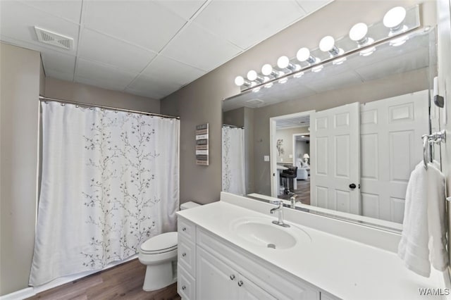 20892 Sharon Dr, Lake View, AL 35111 - full bath with visible vents, toilet, wood finished floors, vanity, and a paneled ceiling