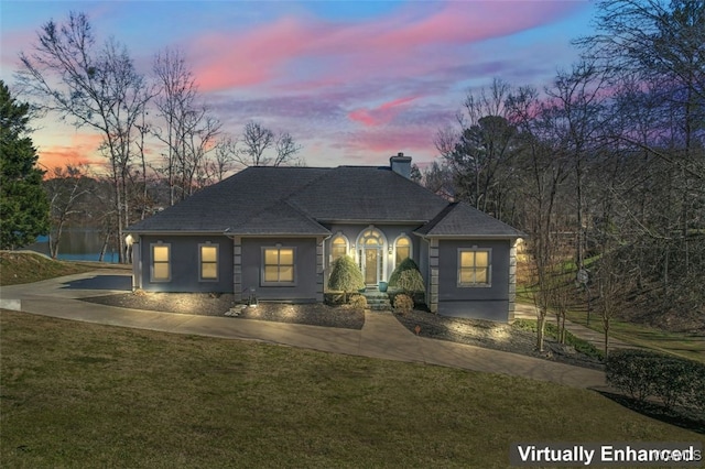 20892 Sharon Dr, Lake View, AL 35111 - view of front of house with a chimney, concrete driveway, a front yard, roof with shingles, and stucco siding