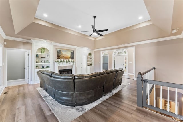 20892 Sharon Dr, Lake View, AL 35111 - living room featuring a fireplace, wood finished floors, a raised ceiling, and a ceiling fan