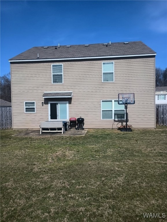 back of property with a lawn, a patio area, and fence