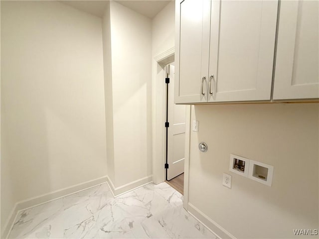 washroom featuring marble finish floor, baseboards, cabinet space, and hookup for a washing machine