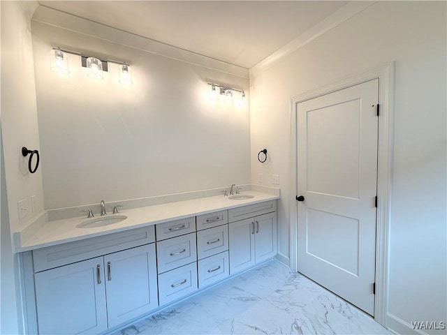 bathroom featuring marble finish floor, a sink, and double vanity