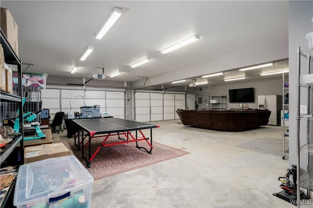garage featuring a garage door opener and refrigerator with ice dispenser