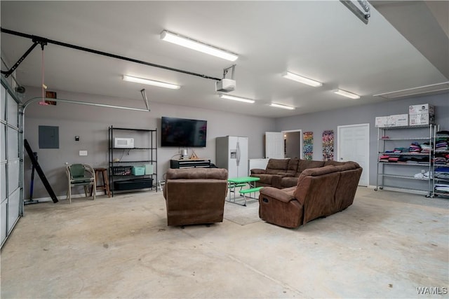 garage with a garage door opener, white refrigerator with ice dispenser, and electric panel