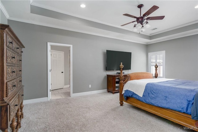 bedroom featuring a tray ceiling, light colored carpet, baseboards, ornamental molding, and visible vents