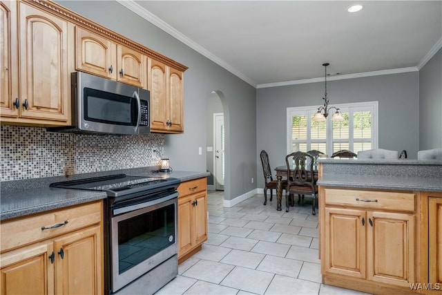 kitchen featuring arched walkways, dark countertops, backsplash, appliances with stainless steel finishes, and ornamental molding