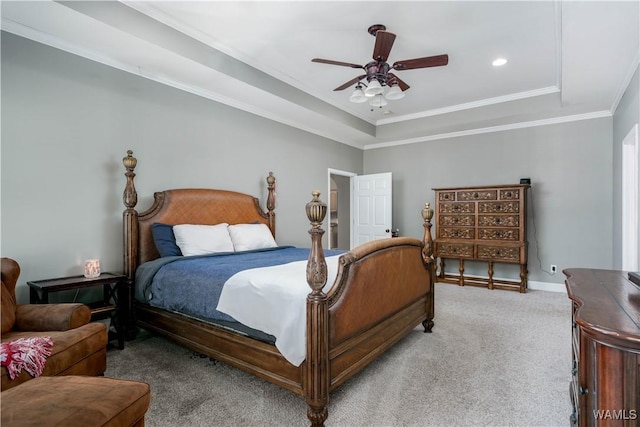 carpeted bedroom with a raised ceiling, baseboards, recessed lighting, ceiling fan, and ornamental molding