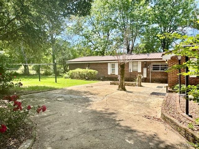 1511 Service St, Demopolis, AL 36732 - back of property featuring a yard and brick siding