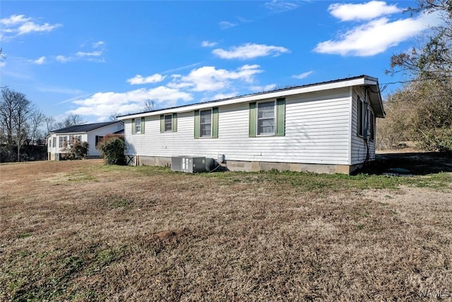 exterior space with cooling unit and a front yard