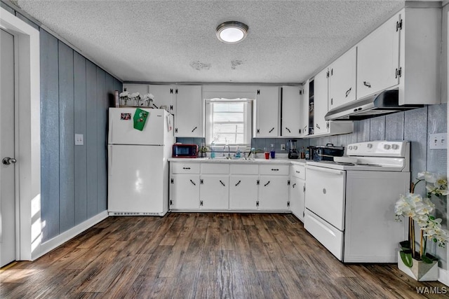 kitchen featuring white appliances, dark wood finished floors, light countertops, under cabinet range hood, and white cabinetry