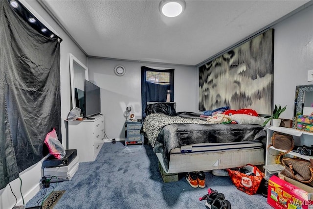 bedroom with a textured ceiling and carpet flooring