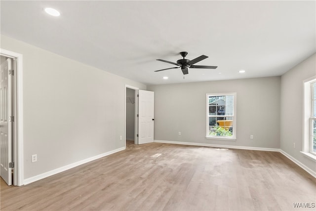 spare room featuring light wood-type flooring and ceiling fan